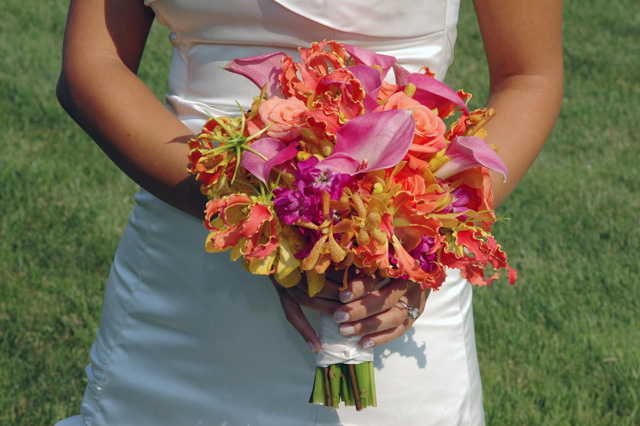 bride holding a tropical wedding bouquet