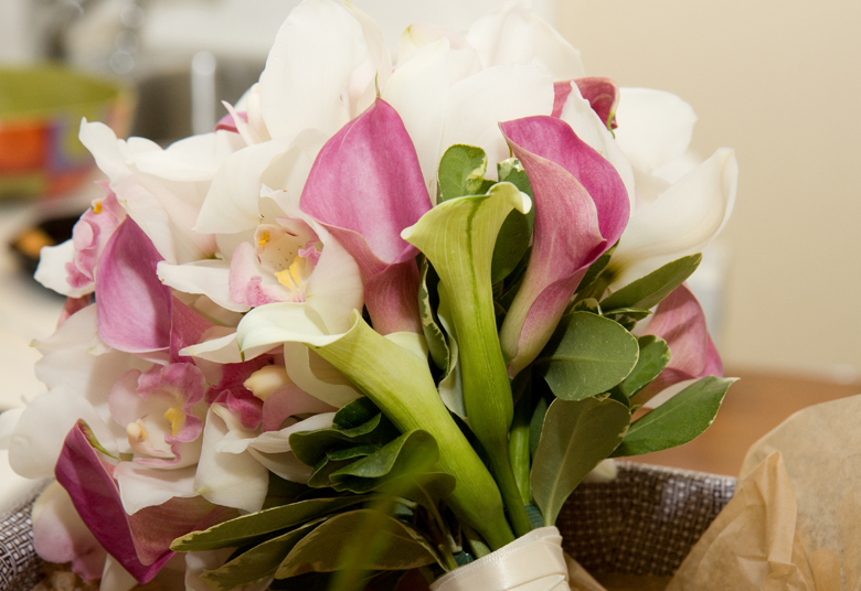 A gorgeous bridal bouquet consisting of white and dark pink calla lilies, as well as orchids.