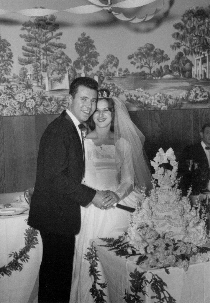 1960s bride and groom cutting their wedding cake