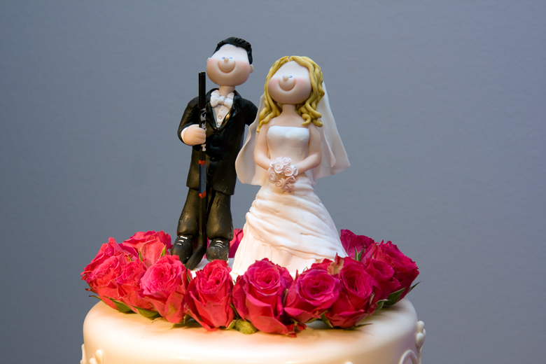 wedding cake topper made of clay figurines of the bride and groom