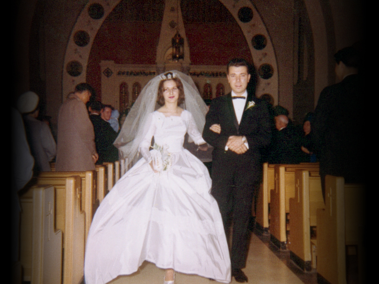 1960s bride and groom walking down the aisle
