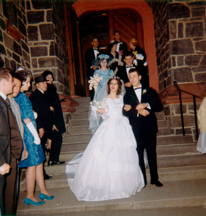 1960s bride and groom leaving a church